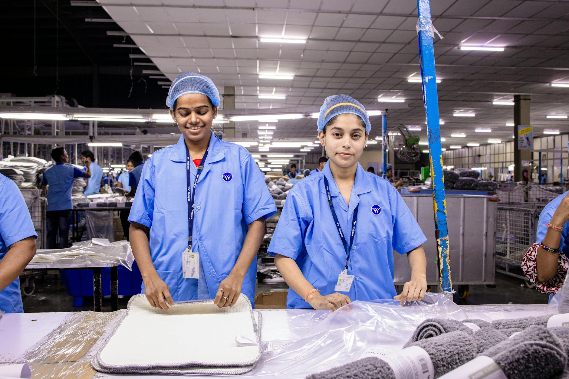Industrial workers in manufacturing facility wearing safety equipment
