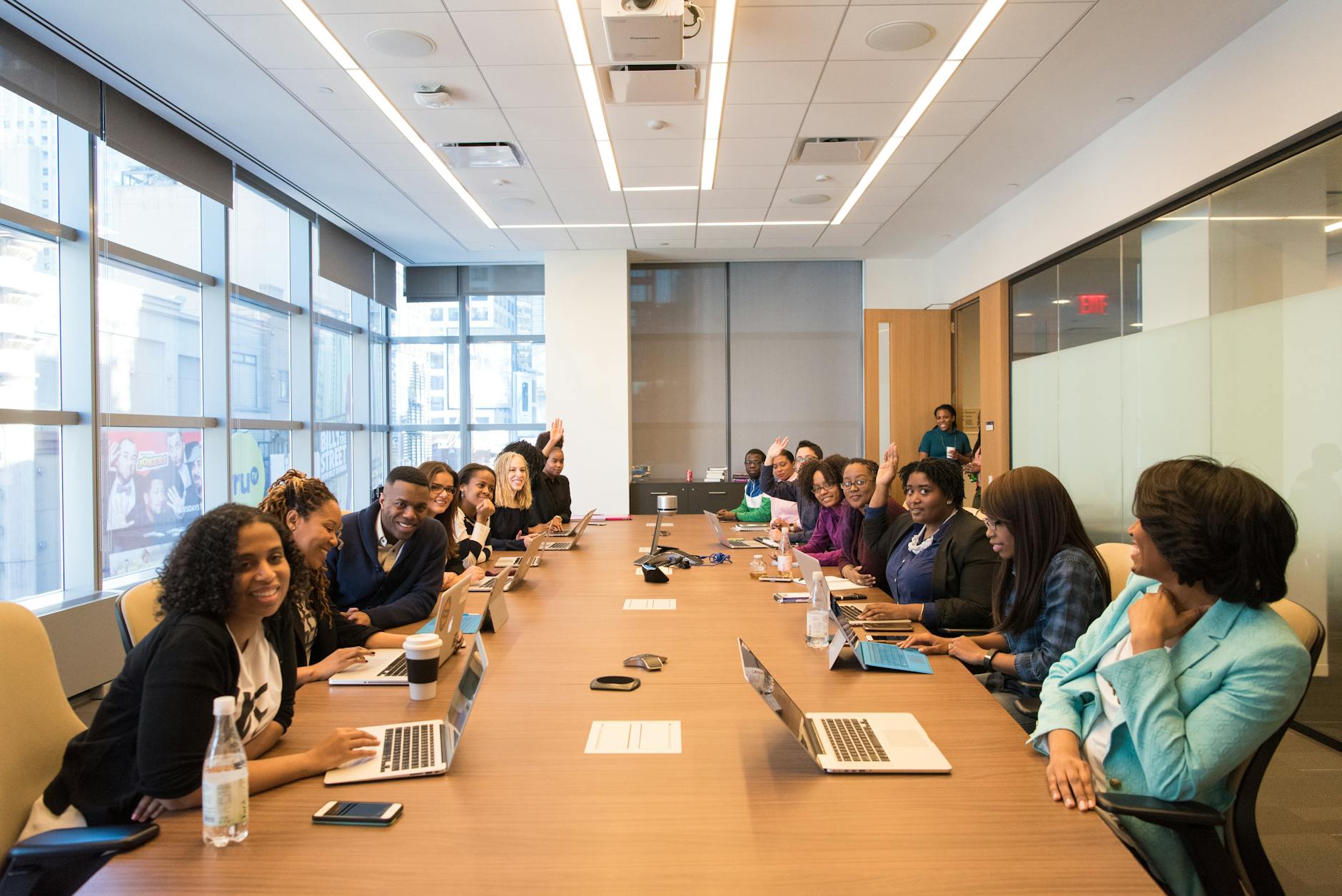 Professional business meeting in modern office space with executives discussing strategy