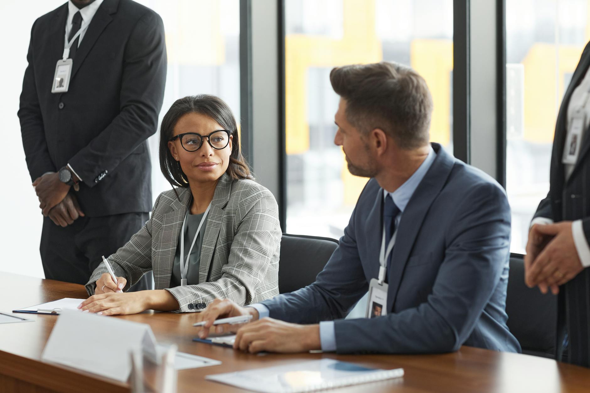 Professional business meeting with documents and charts on table