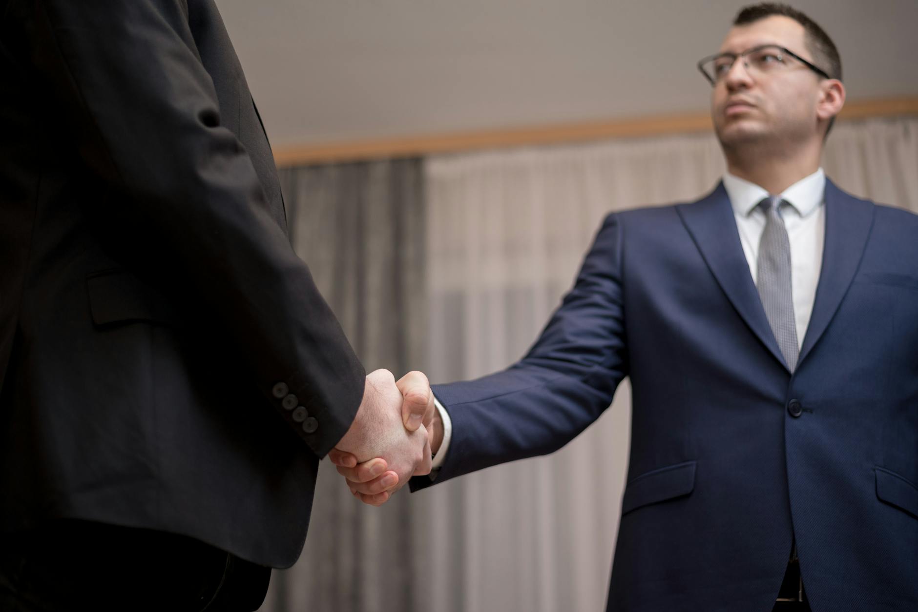 Professional business meeting with handshake representing wealth planning discussions
