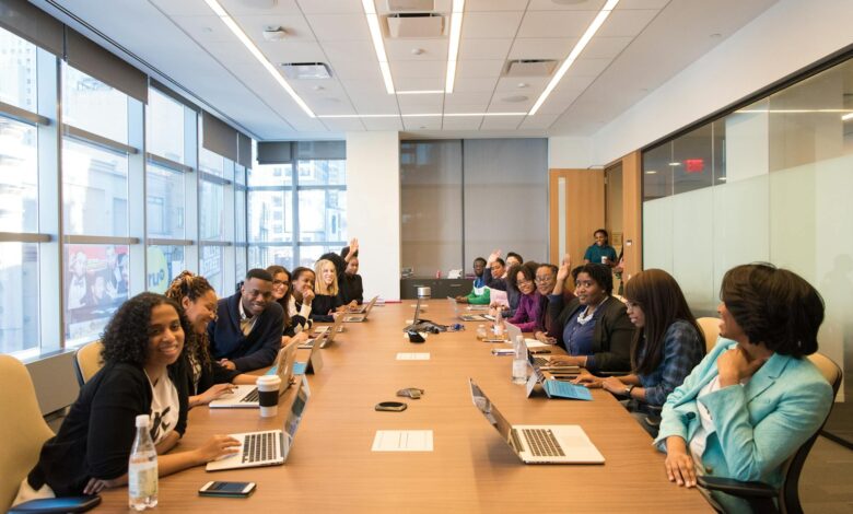 Business professionals discussing employee benefits and stock options in modern office setting