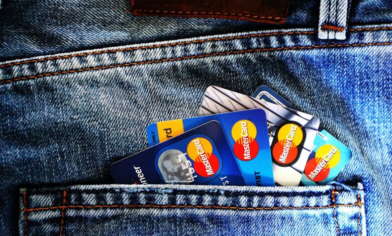 Multiple credit cards arranged in a leather wallet showing various card designs and logos