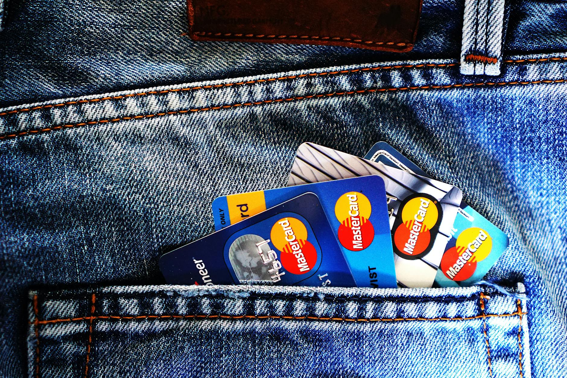 Multiple credit cards arranged in a leather wallet showing various card designs and logos