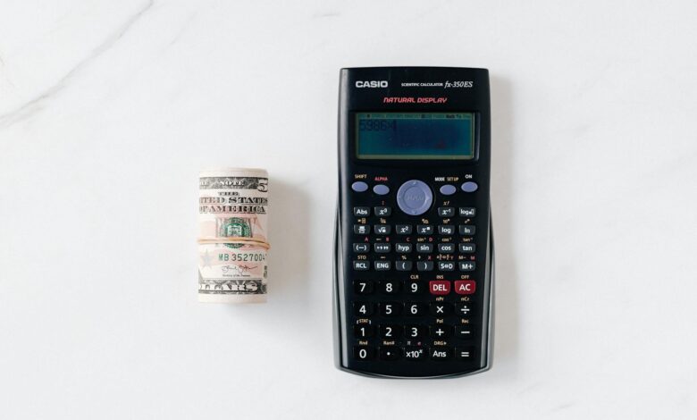 Calculator and financial documents showing CD interest rate calculations
