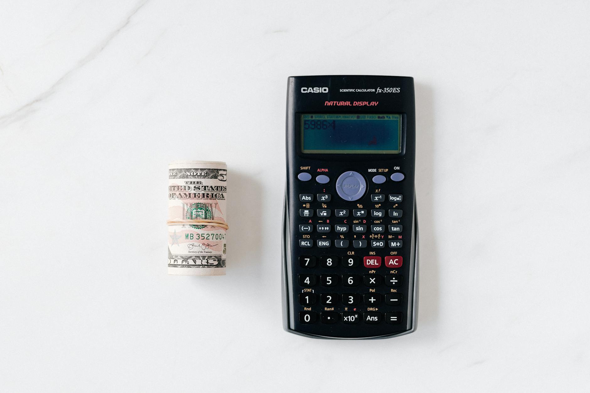 Calculator and financial documents showing CD interest rate calculations