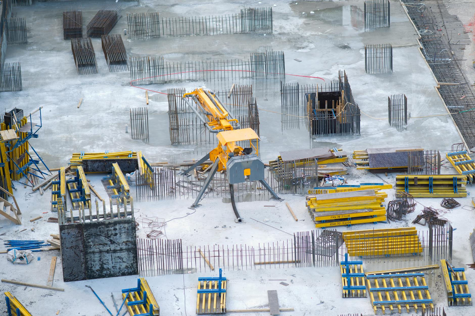 Industrial construction site with cranes and steel framework of new manufacturing facility