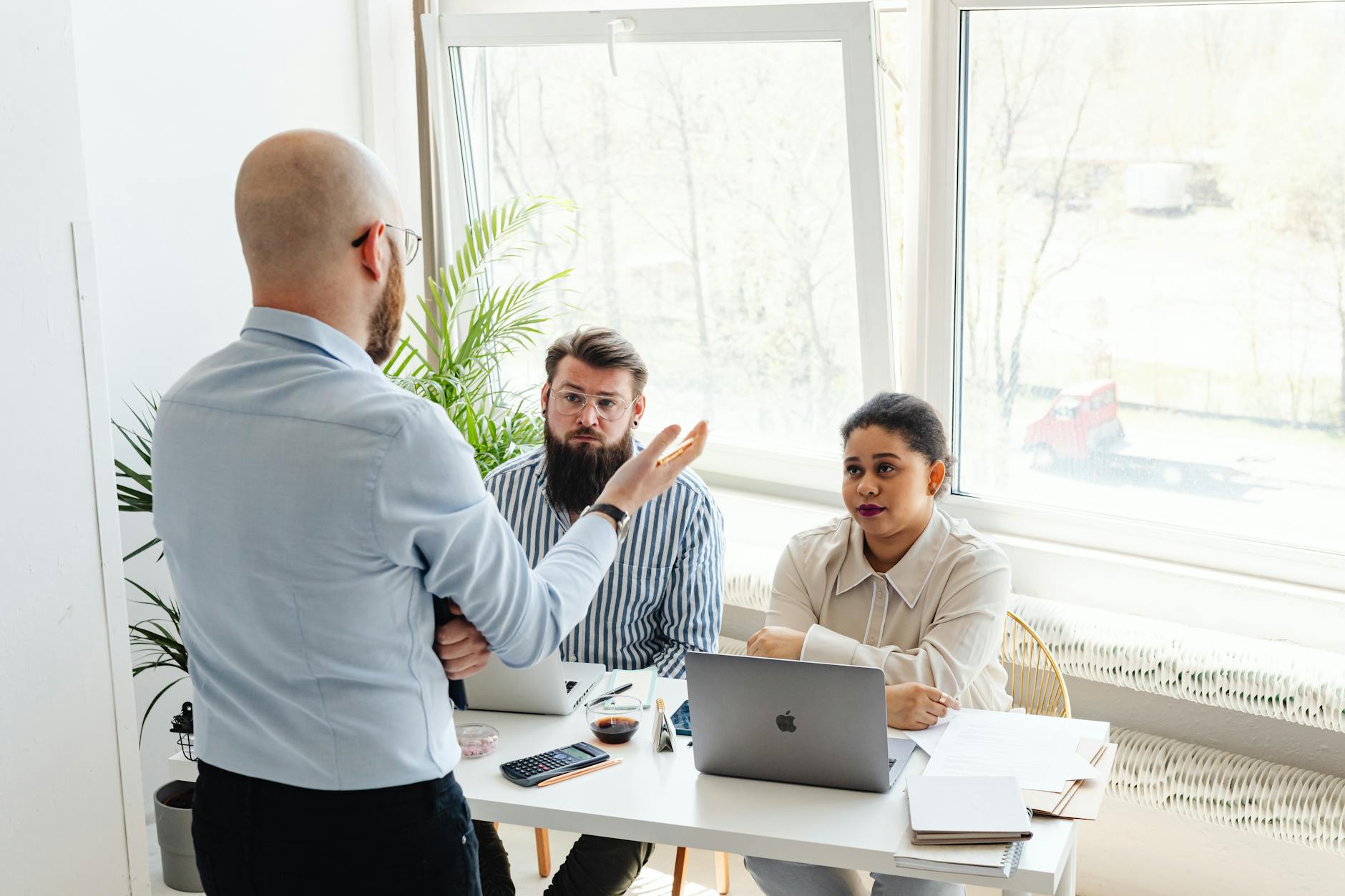 Professional job interview setting with diverse candidates and interviewers in government office