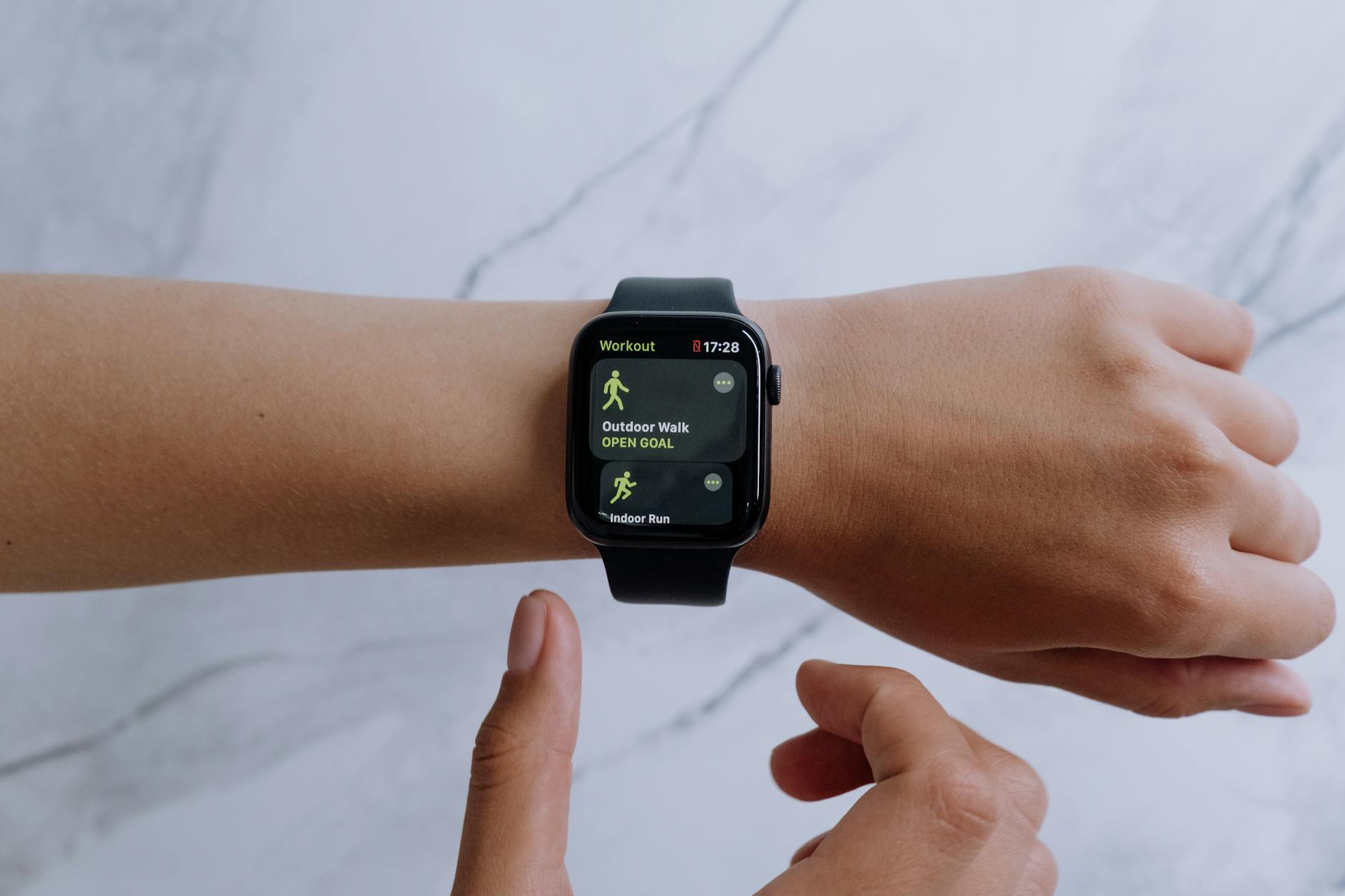 Person wearing fitness tracker device during workplace wellness program