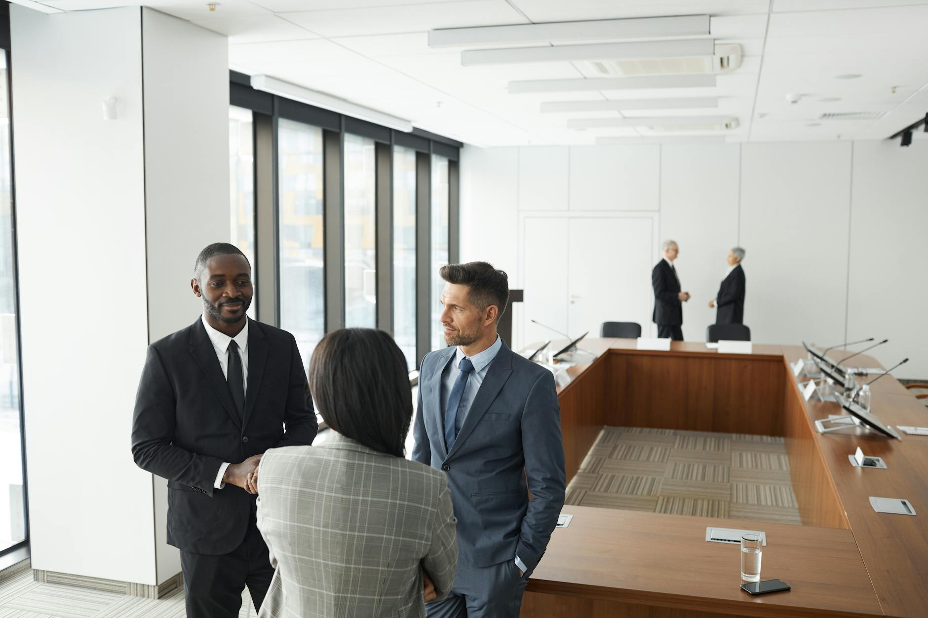 Professional business meeting with financial documents and portfolio discussions