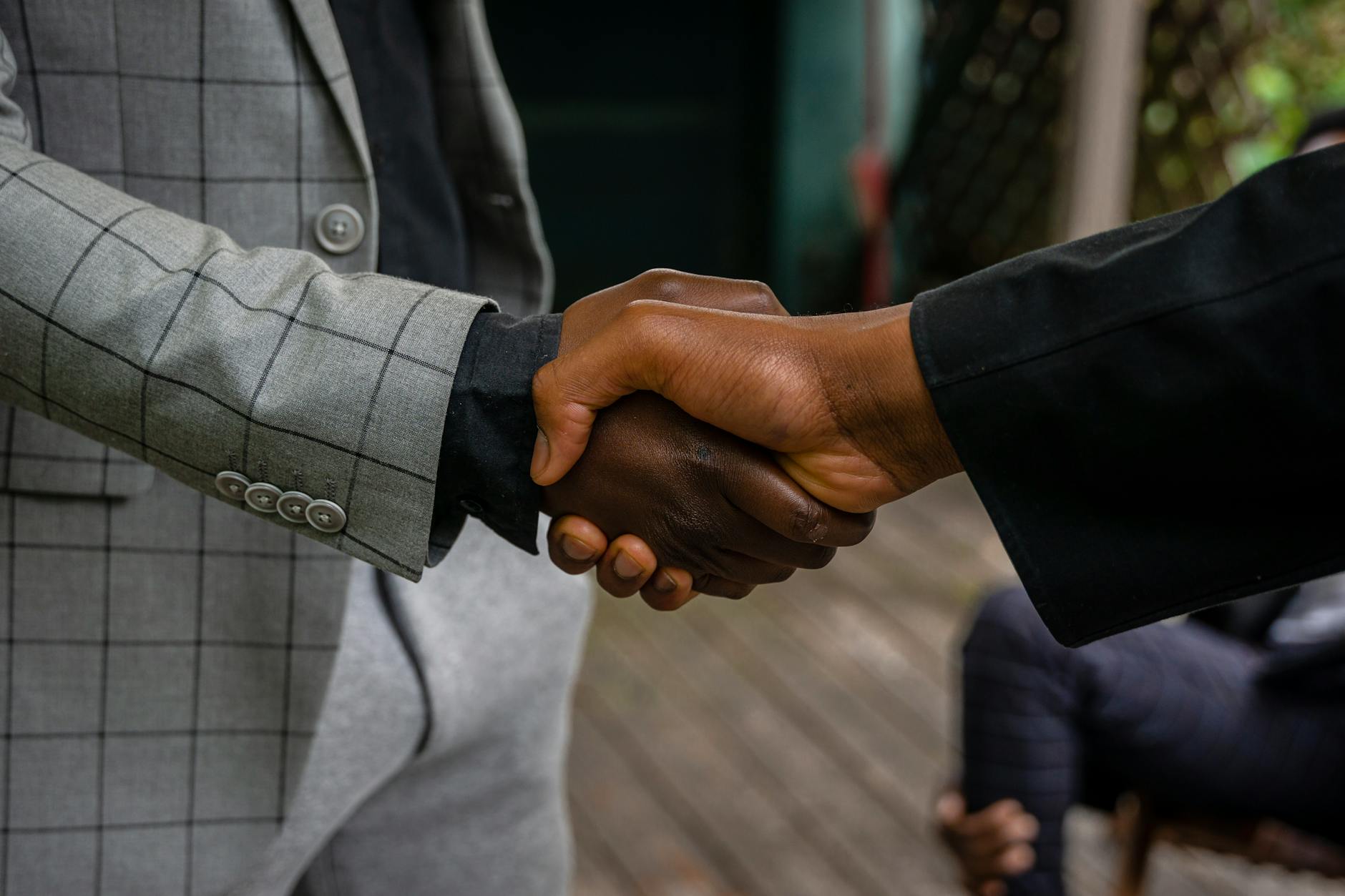 Professional business meeting handshake representing negotiations between state and federal banking officials
