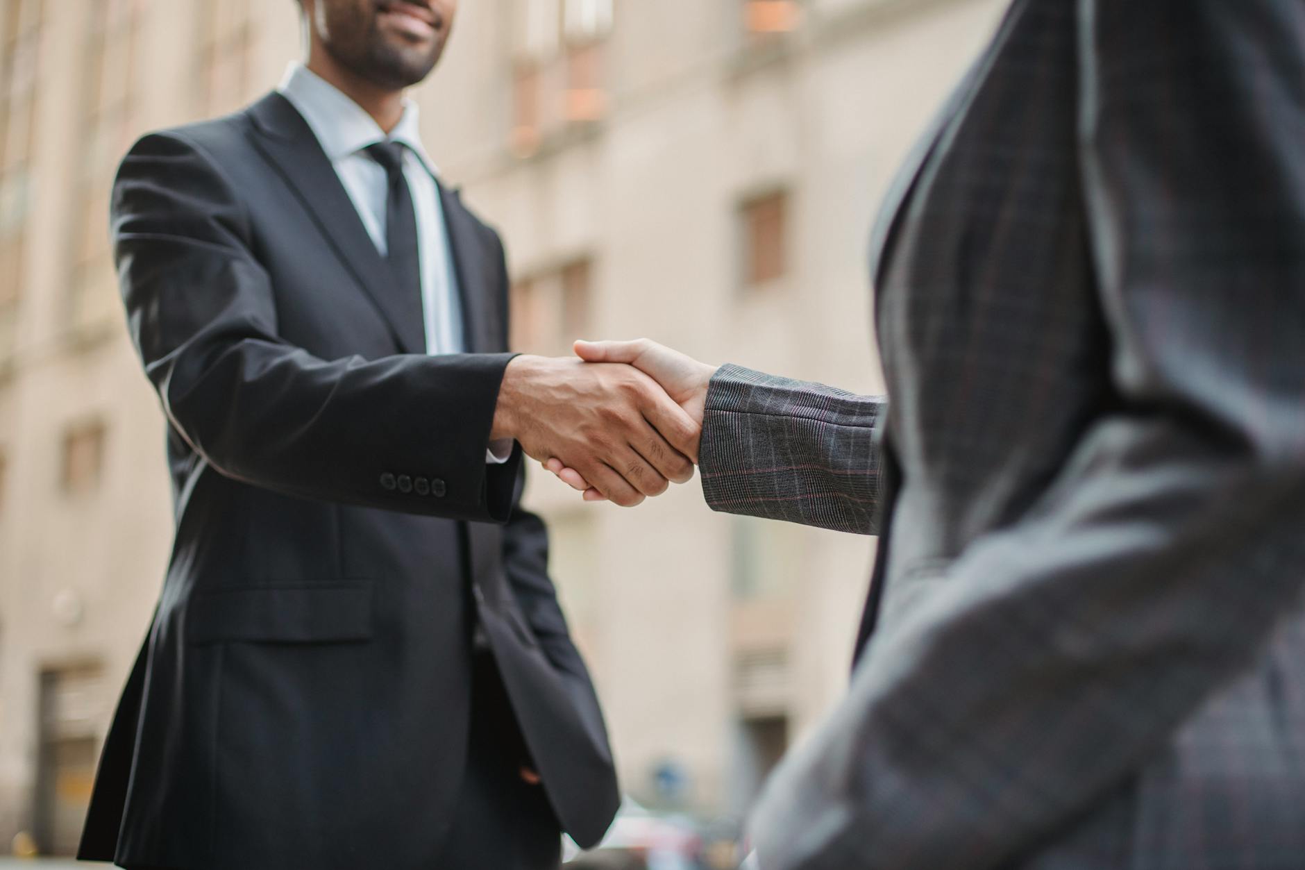 Business handshake representing financial partnership agreements