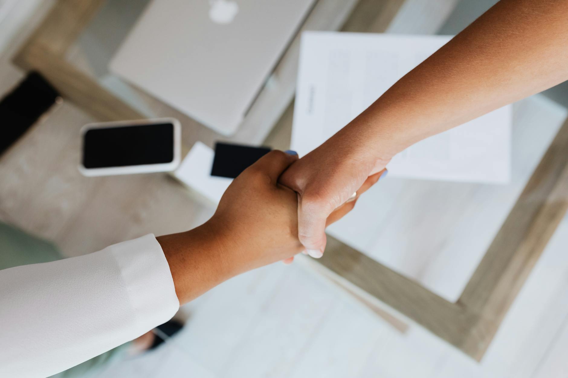 Professional handshake between business partners in office setting