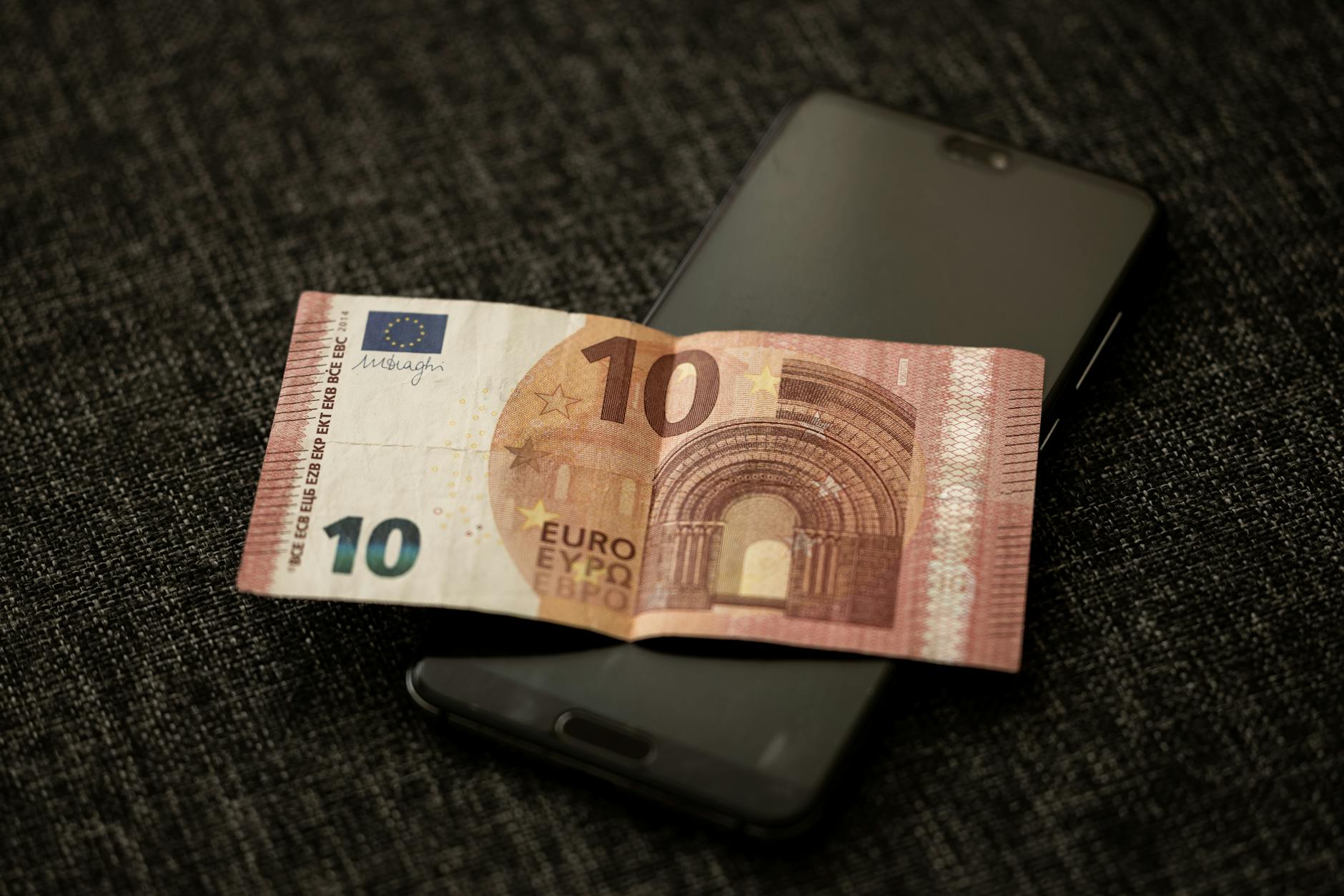 Person using mobile banking app on smartphone for financial transactions