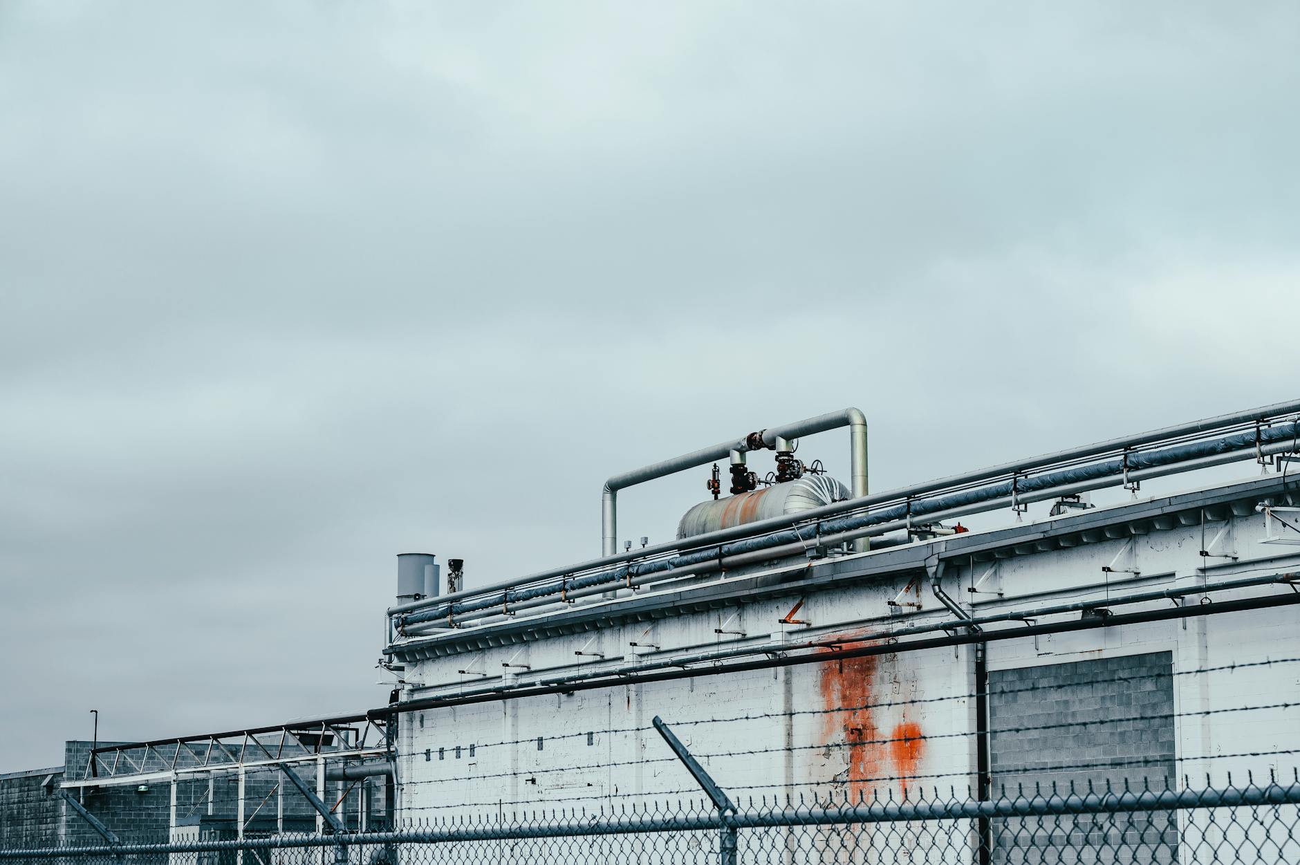 Modern industrial manufacturing facility exterior with parking lot