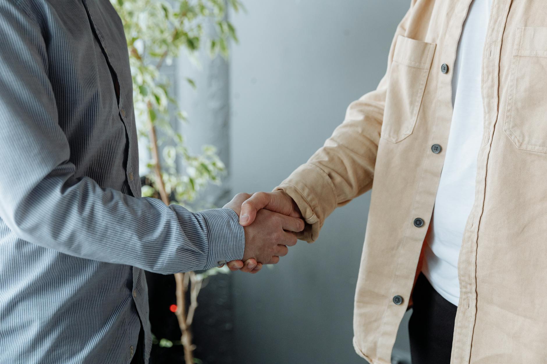 Professional handshake between business partners during formal meeting