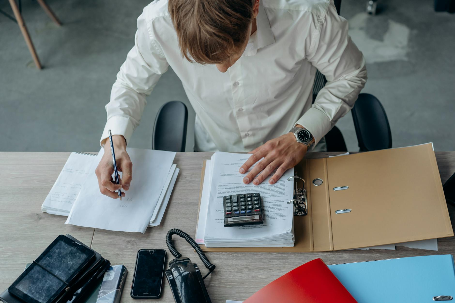 Financial documents and a laptop on a desk representing wealth management and tax planning paperwork