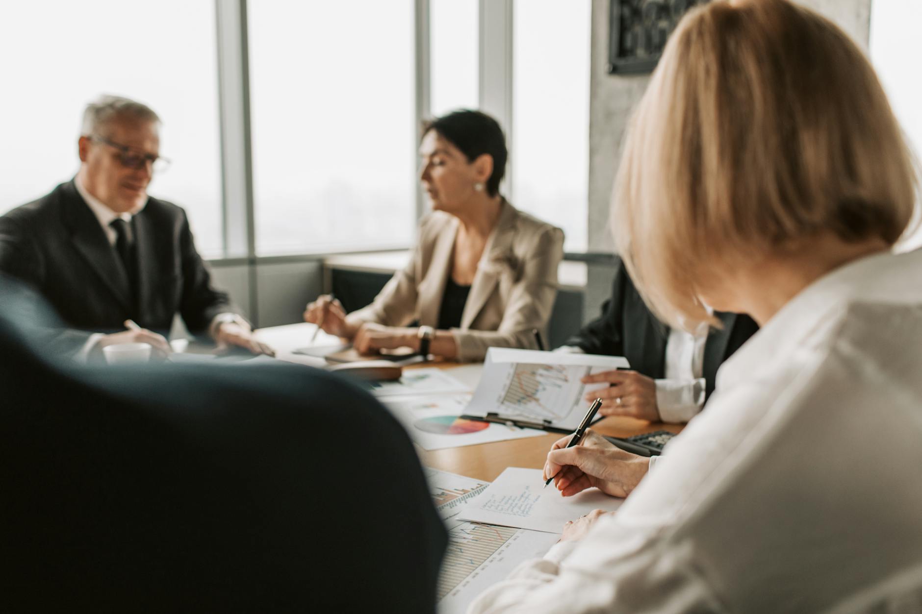 Investors gathered at a formal shareholder meeting in a conference room