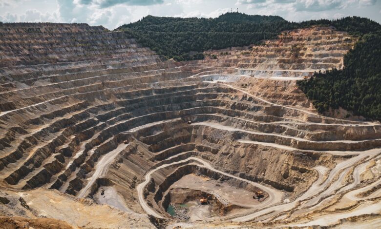 Open pit uranium mine with industrial equipment and exposed ore terrain