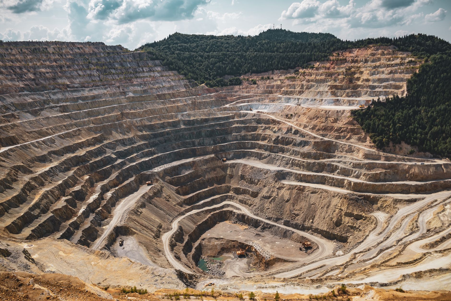 Open pit uranium mine with industrial equipment and exposed ore terrain