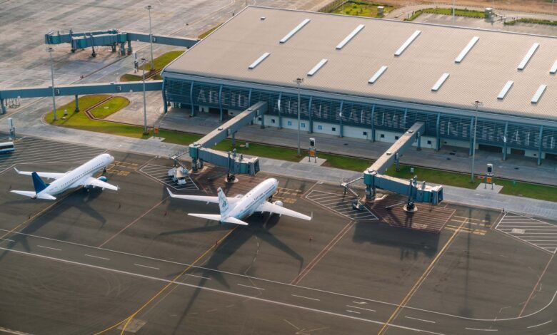 Interior of a busy international airport terminal with gates and departure boards