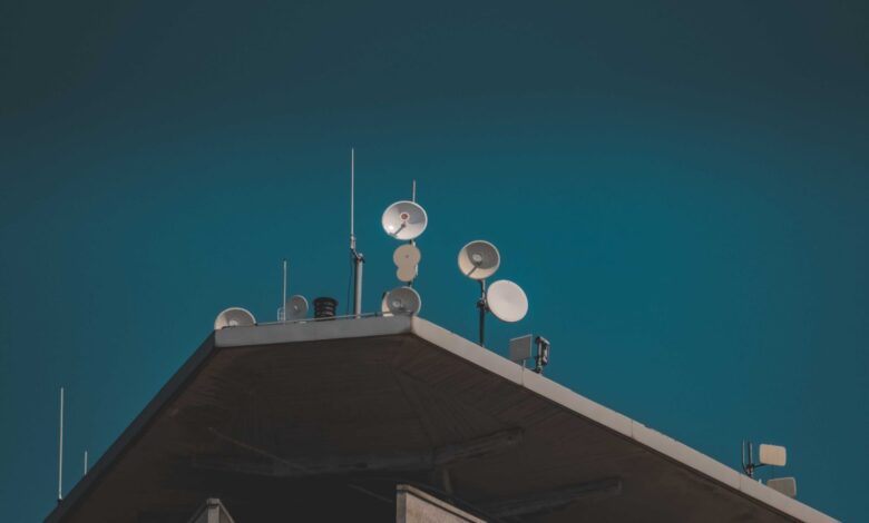 Large satellite dish pointing skyward against a clear blue sky