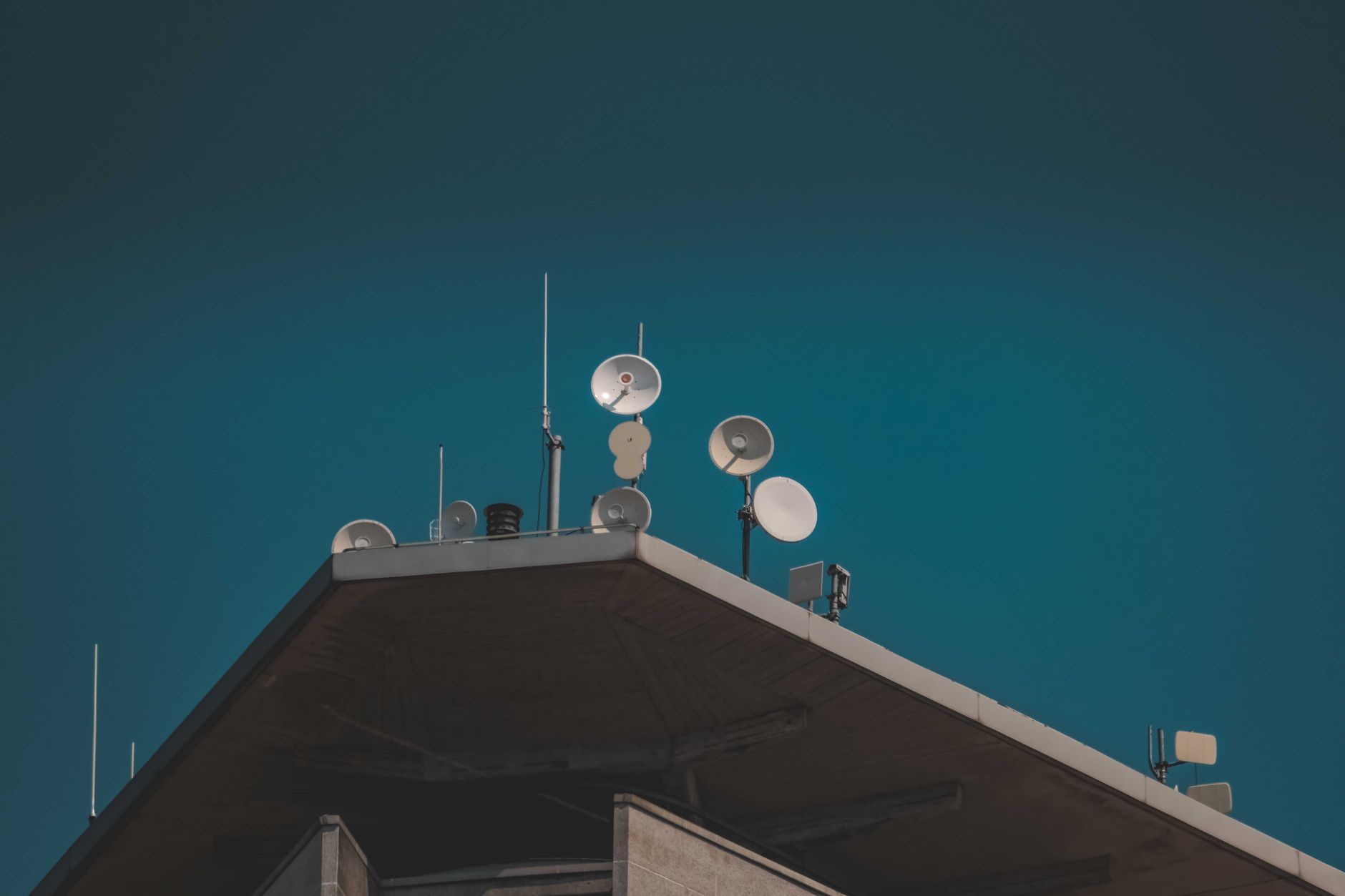 Large satellite dish pointing skyward against a clear blue sky