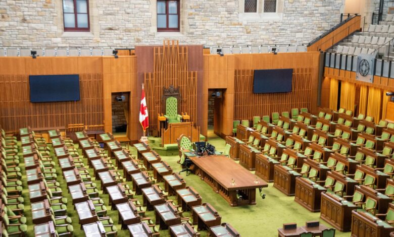 Empty state legislative chamber with rows of seats and a podium at the front