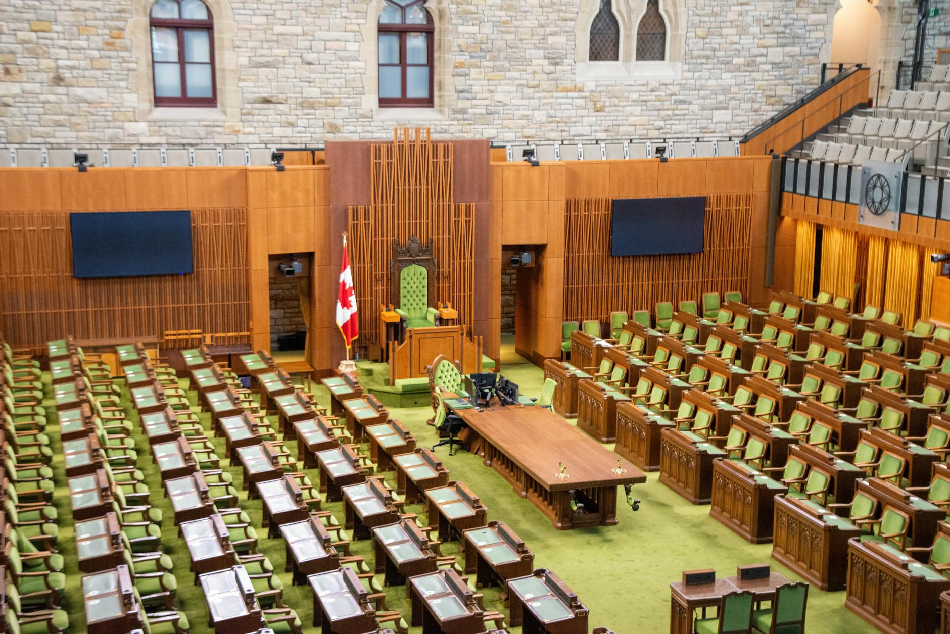 Empty state legislative chamber with rows of seats and a podium at the front
