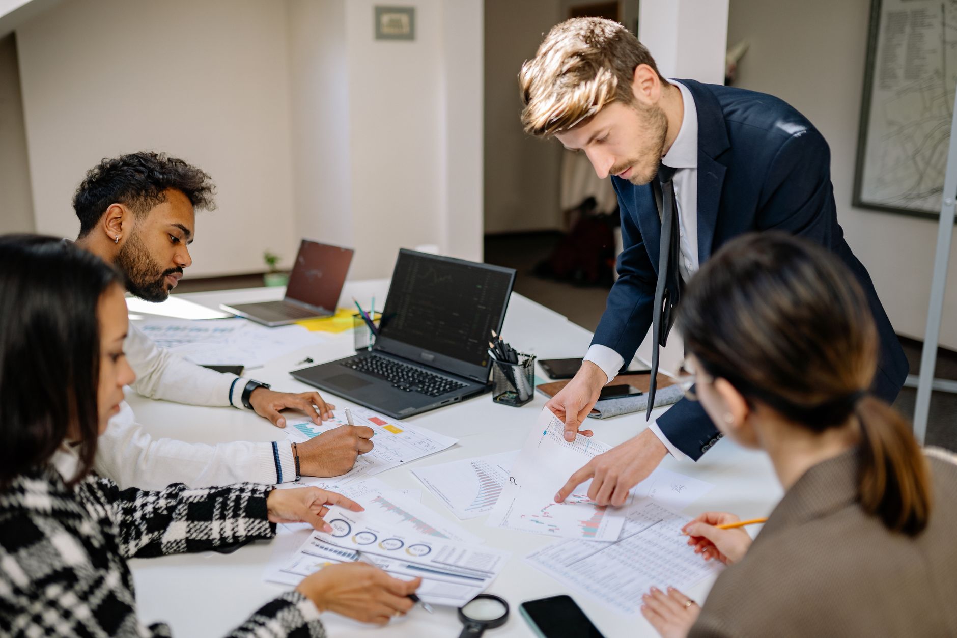Investment professionals reviewing financial documents at a conference table