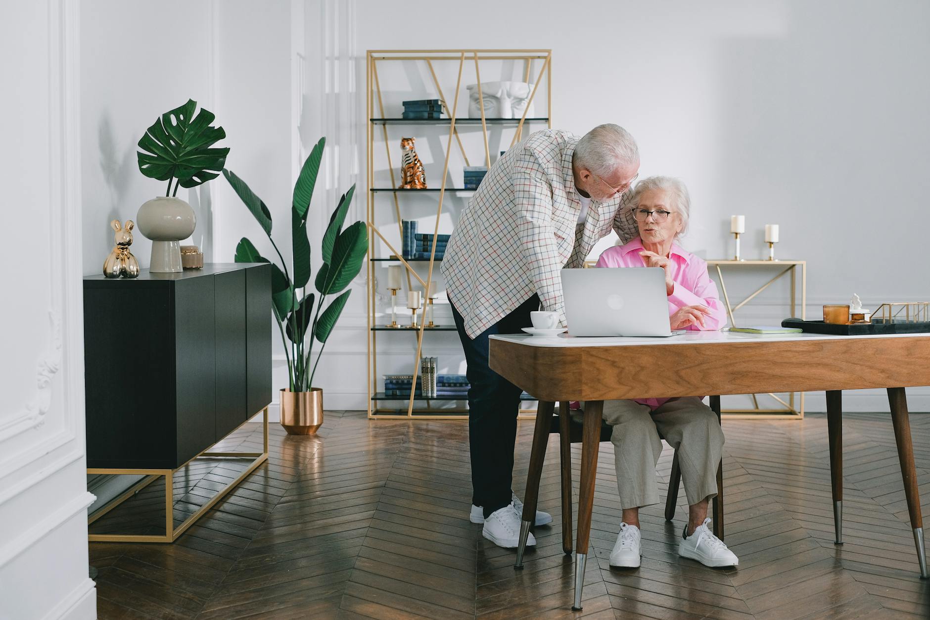 Retired couple reviewing investment portfolio documents at home