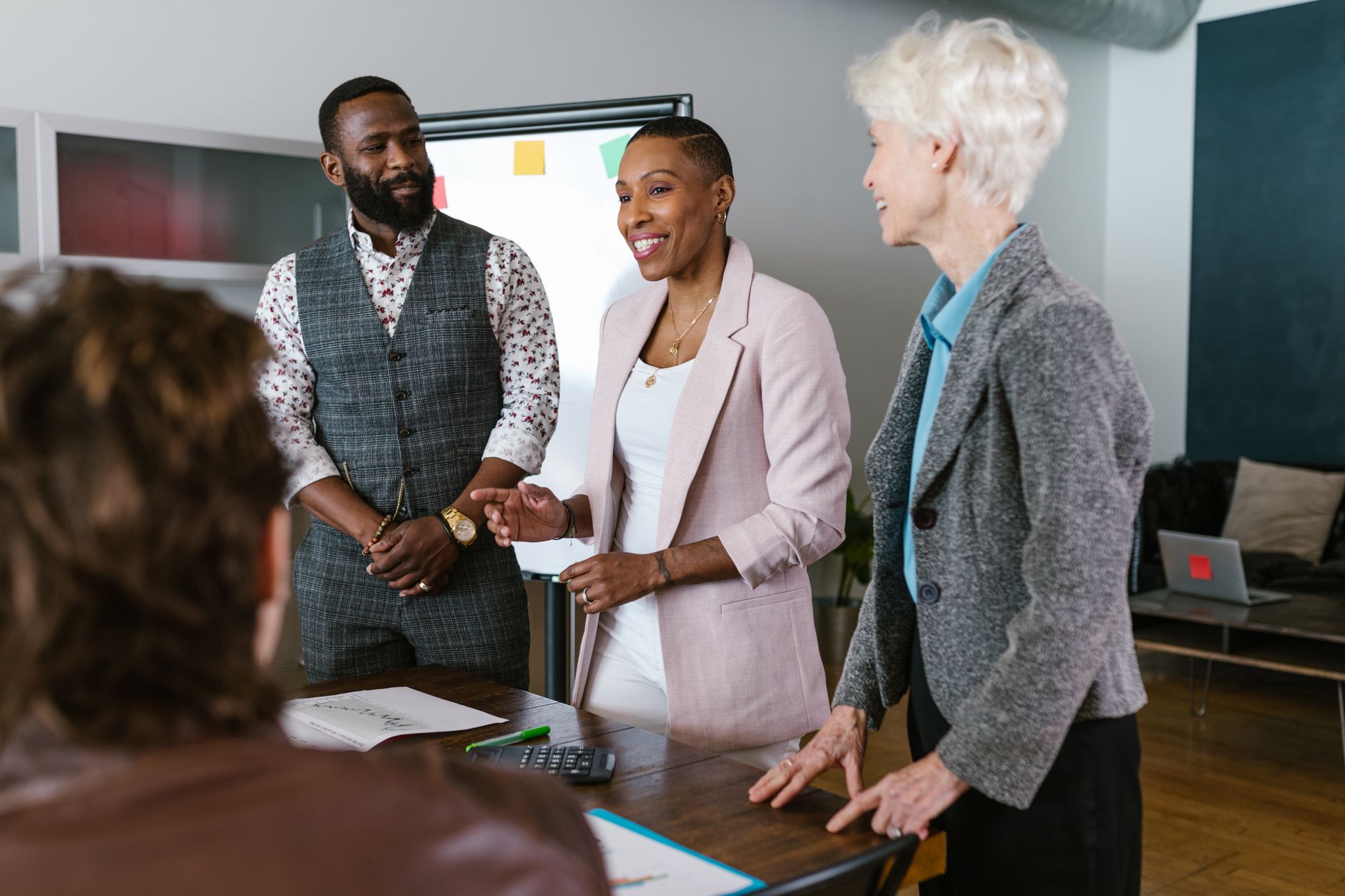 Business professionals reviewing financial documents in a formal meeting room