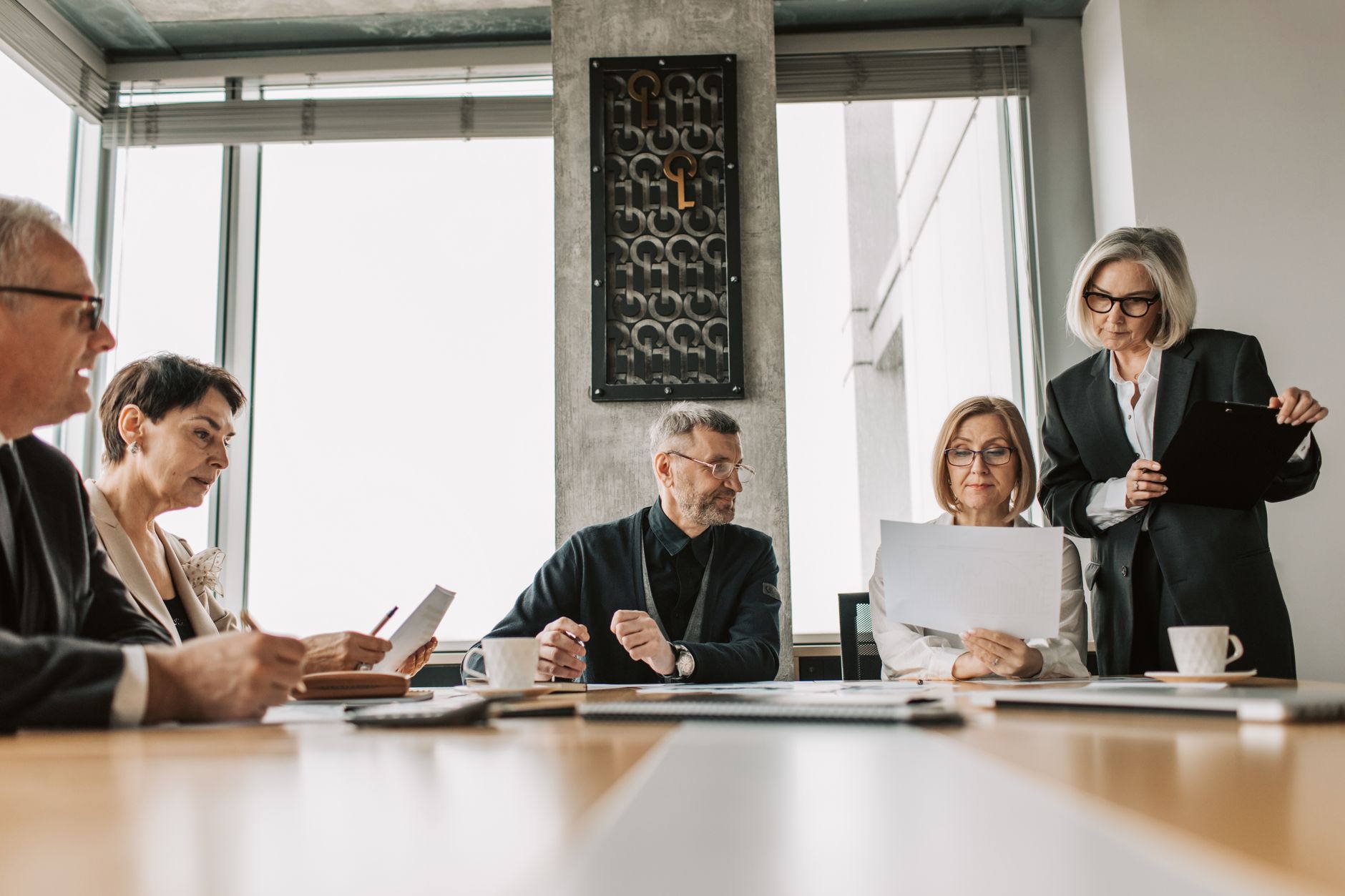 Professionals in a boardroom meeting discussing investment risk and structured finance strategy