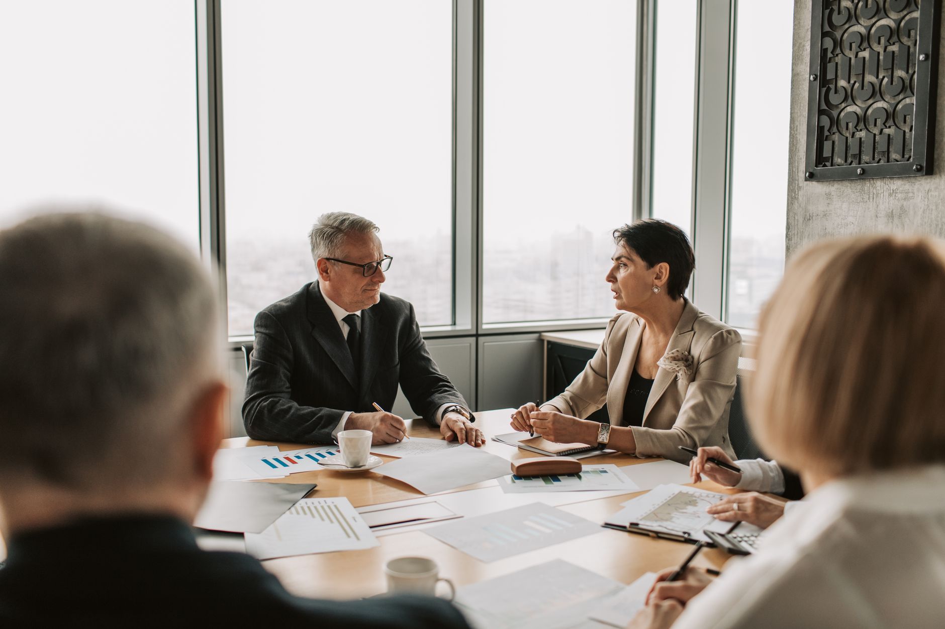 Institutional investors reviewing financial documents at a conference table
