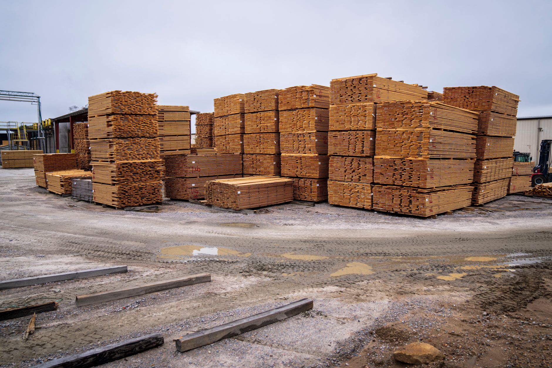 Stacked lumber at a sawmill facility representing timber supply and wood product inventory