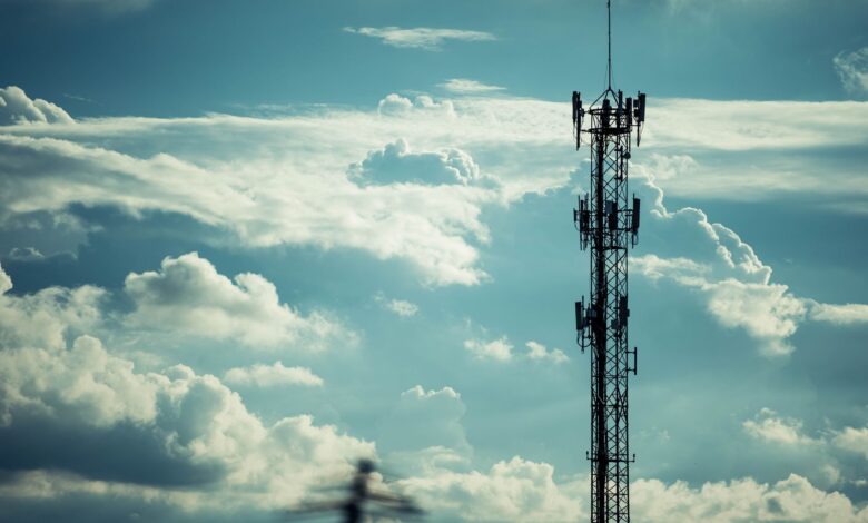 Wireless cell tower against a clear sky representing infrastructure ground lease investments