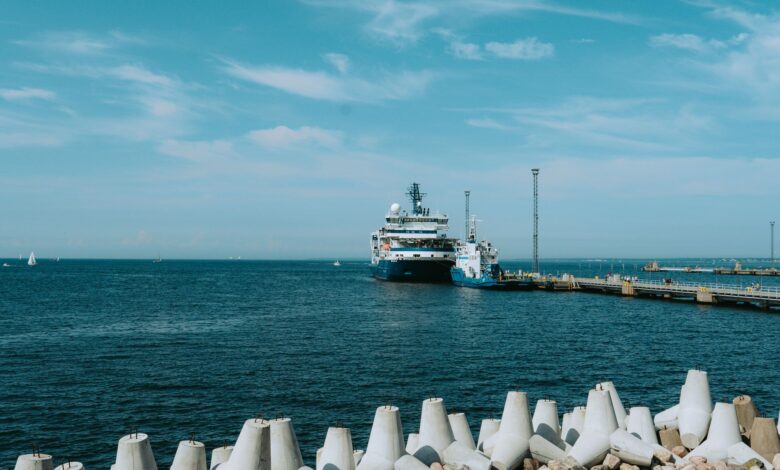 Large liquefied natural gas terminal with storage tanks along a coastal waterway