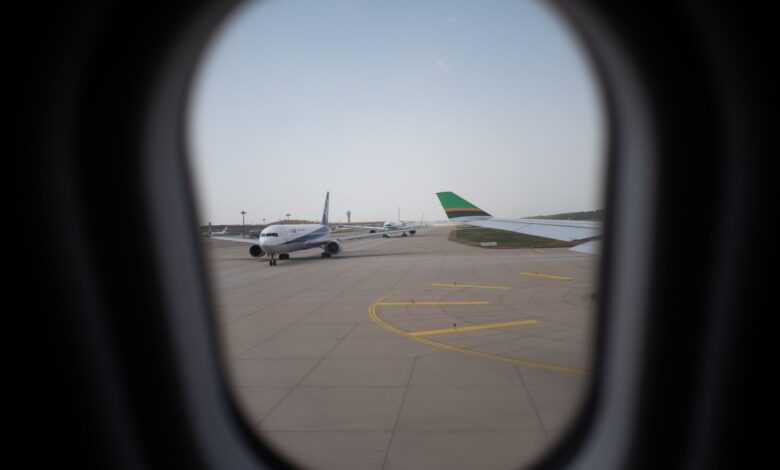 Wide view of airport apron with aircraft stands and ground infrastructure