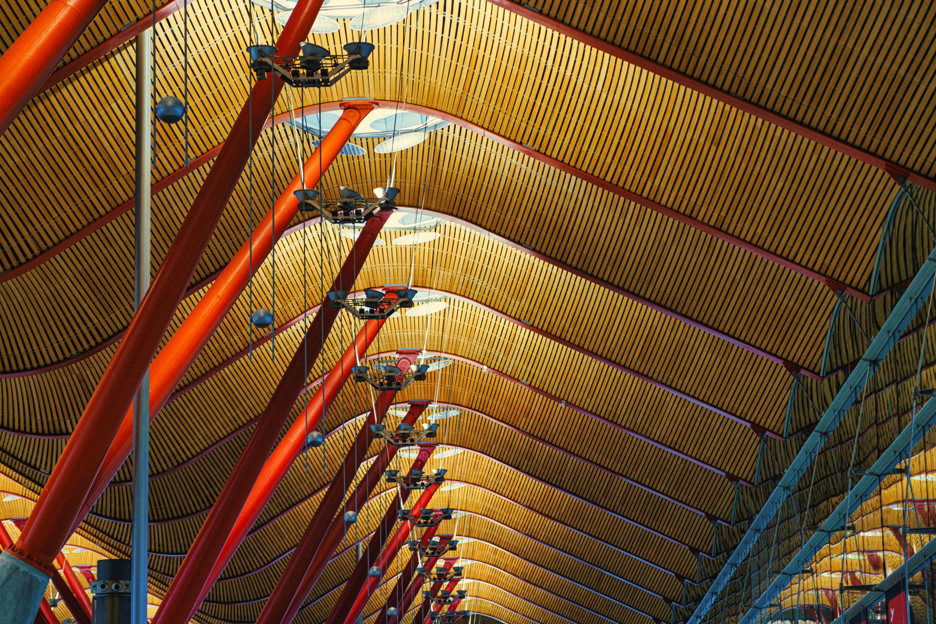 Modern airport terminal with travelers and gates visible in background