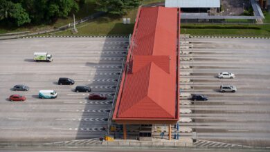 Aerial view of a multi-lane toll road cutting through open landscape