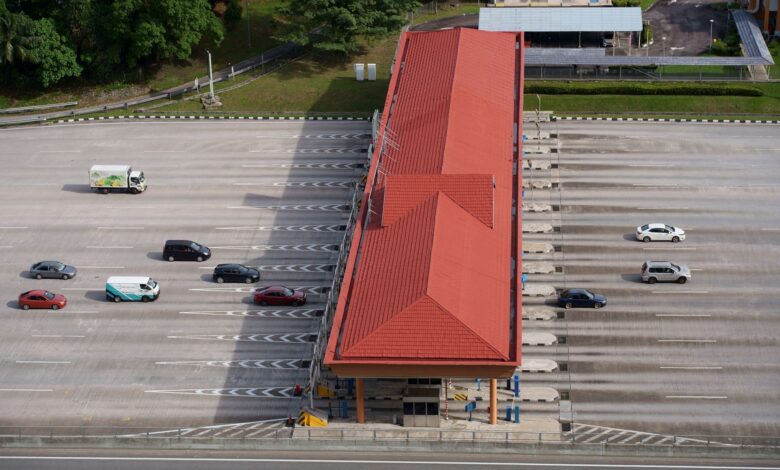 Aerial view of a multi-lane toll road cutting through open landscape
