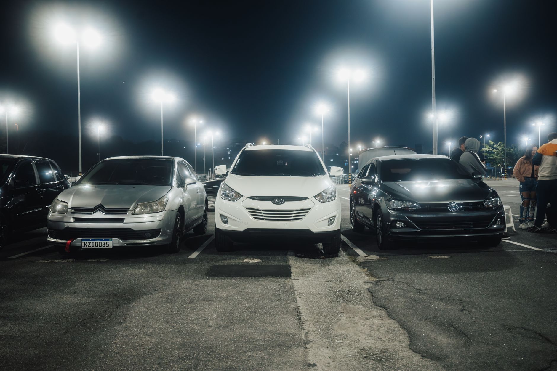 Large airport parking structure with rows of vehicles under clear sky