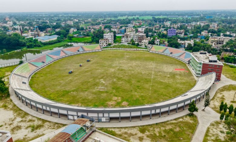 Aerial view of a large sports stadium surrounded by urban infrastructure