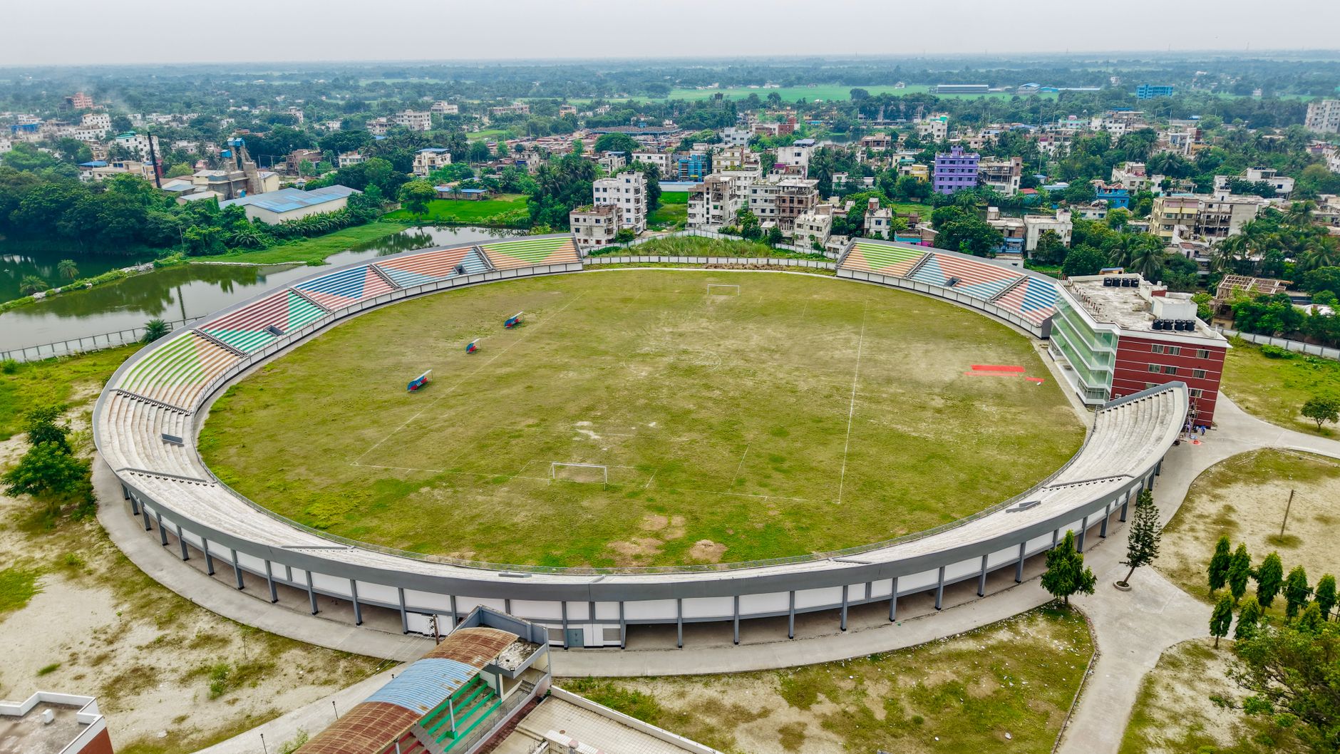 Aerial view of a large sports stadium surrounded by urban infrastructure