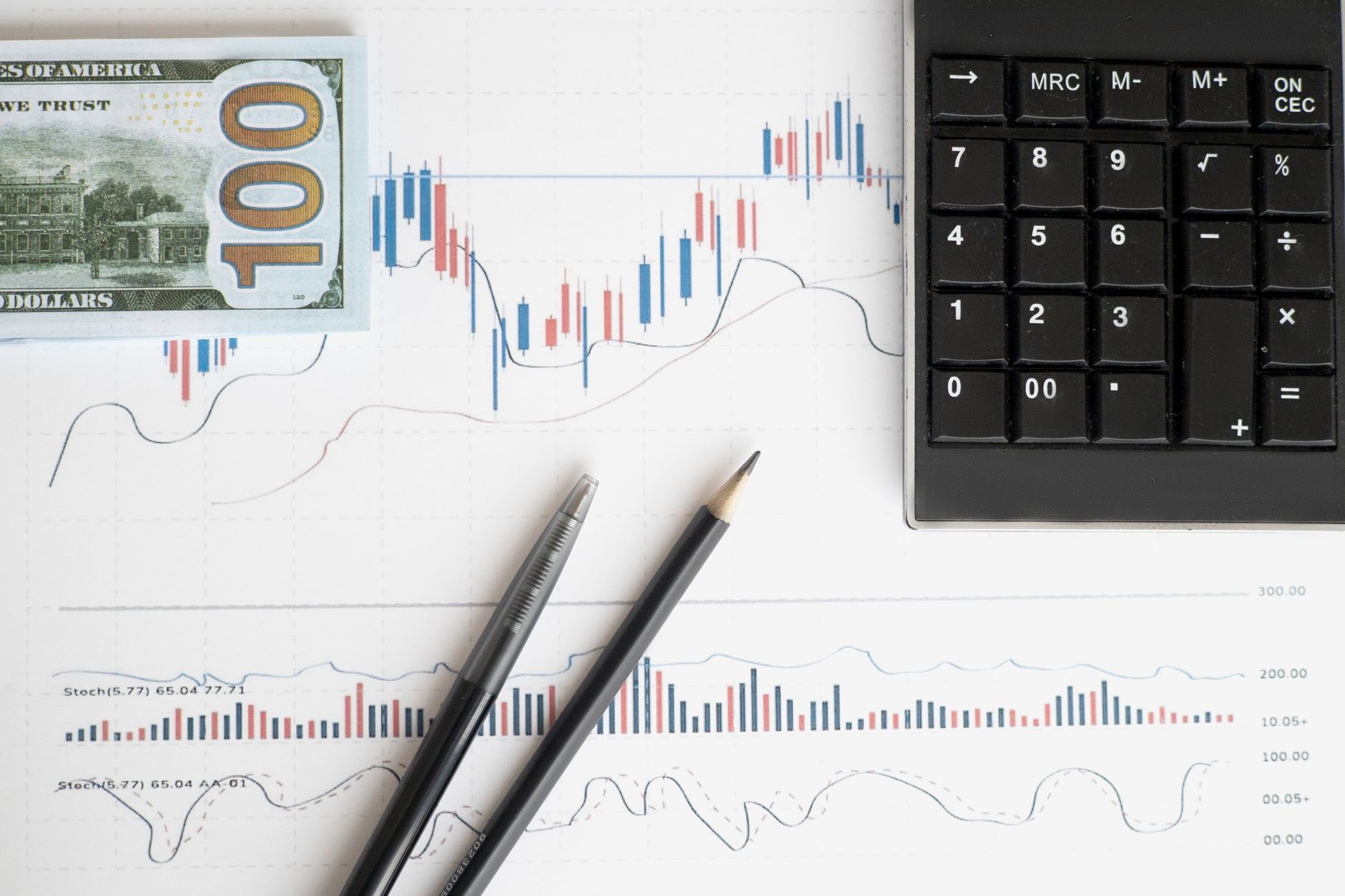 Investment portfolio charts and financial data displayed on screens
