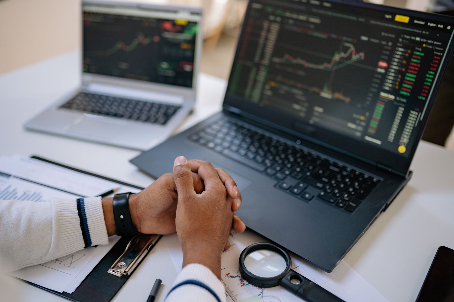 Traders at a financial desk reviewing investment screens representing hedge fund activity in alternative assets
