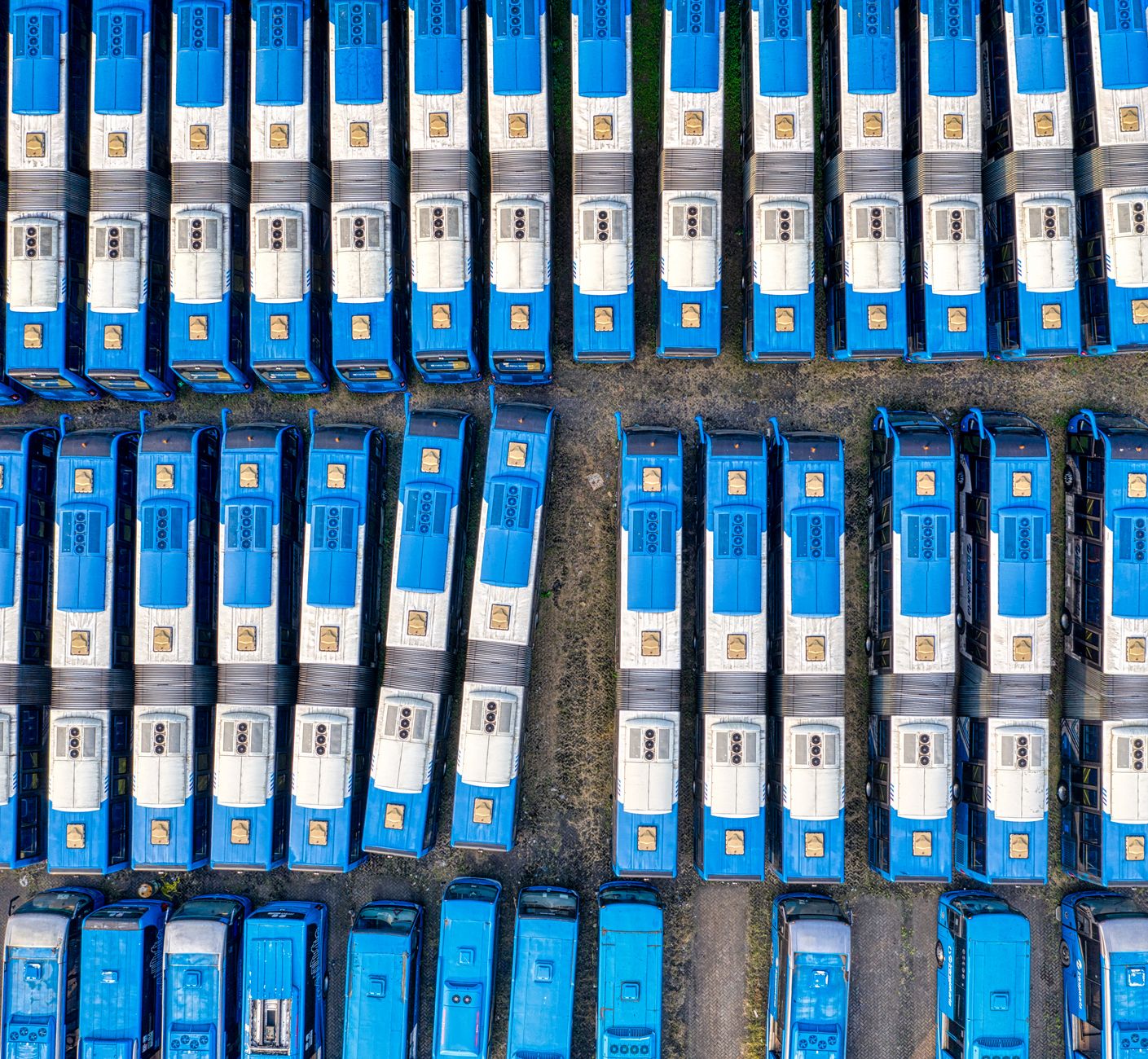Large commercial fleet trucks parked at a logistics depot awaiting fuel