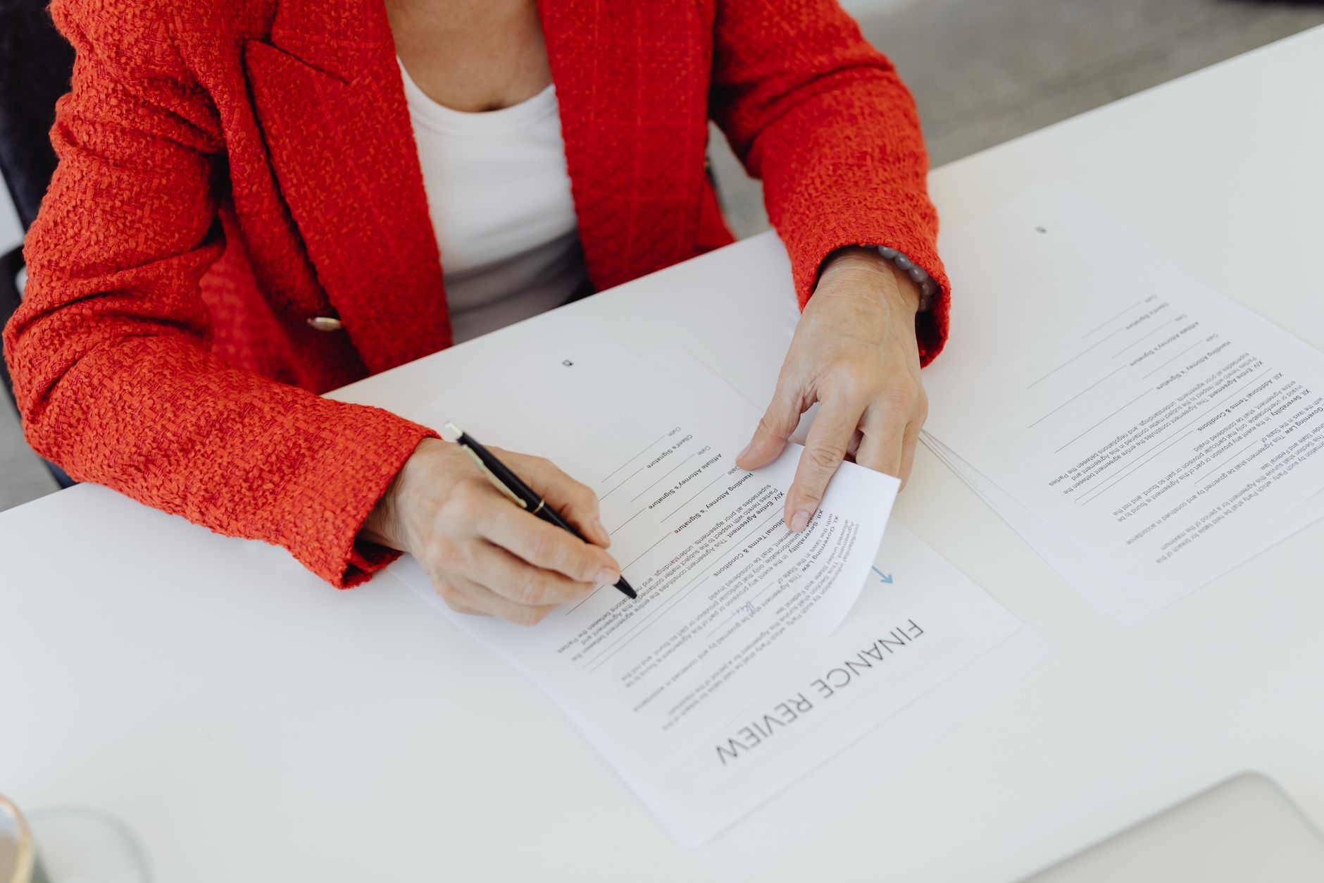 Business professionals reviewing and signing financial investment documents