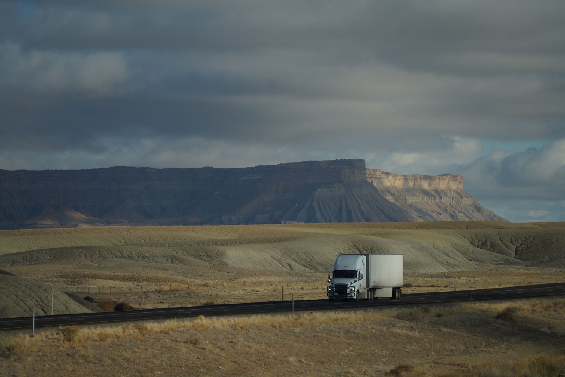 Commercial freight truck driving on a major highway near a port city
