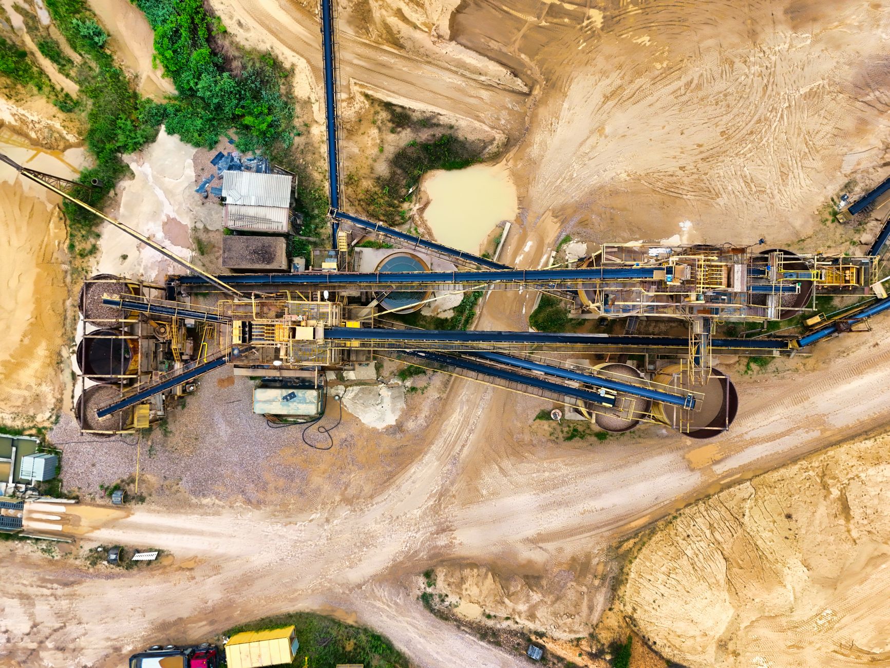 Aerial view of an open-pit gold mining operation showing large-scale extraction