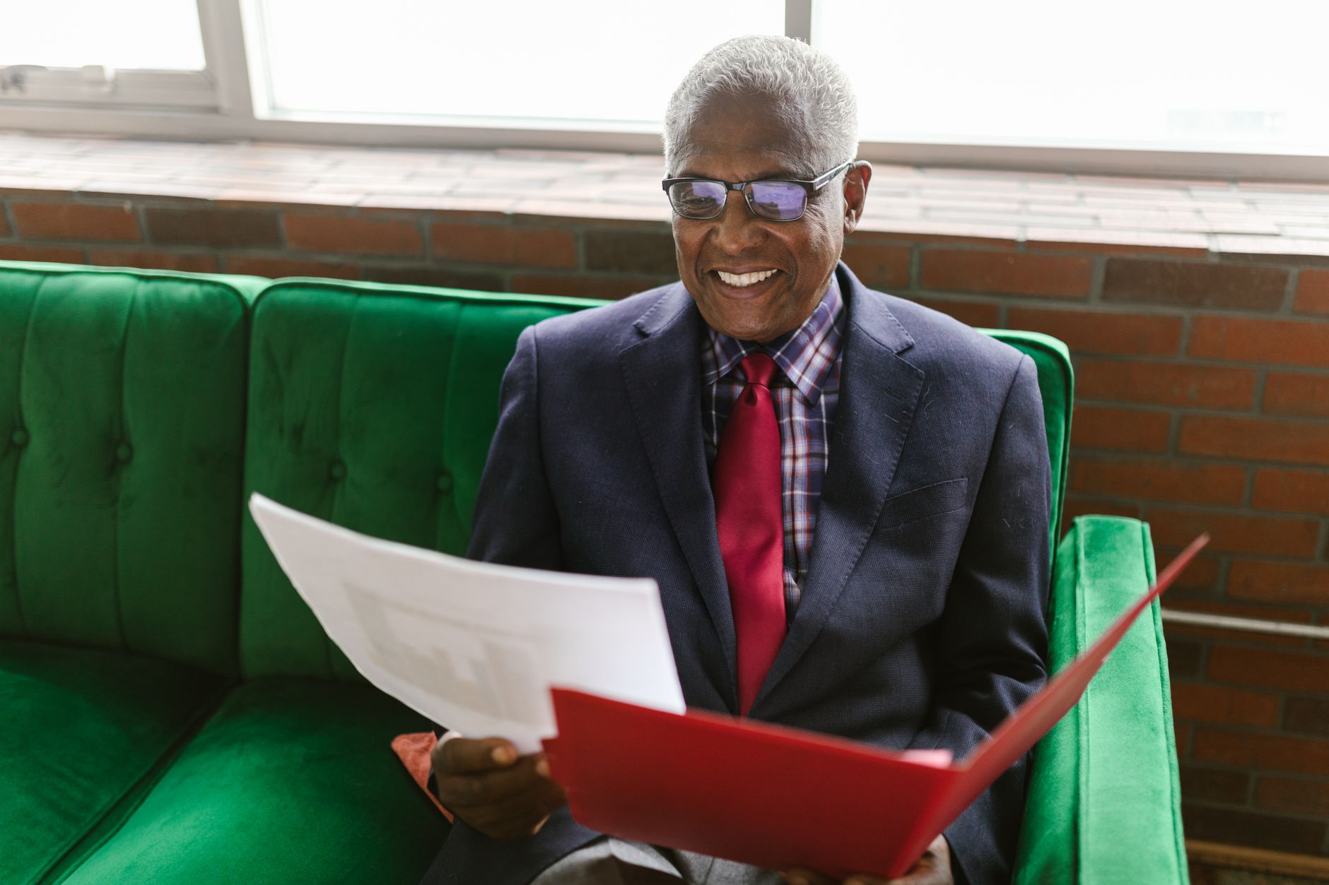 Institutional investors reviewing portfolio documents at a formal boardroom meeting